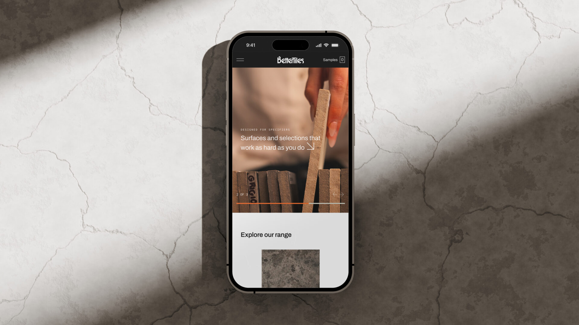 The mobile BetterTiles website displayed on an iPhone 16 Pro, situated on a concrete tile.
